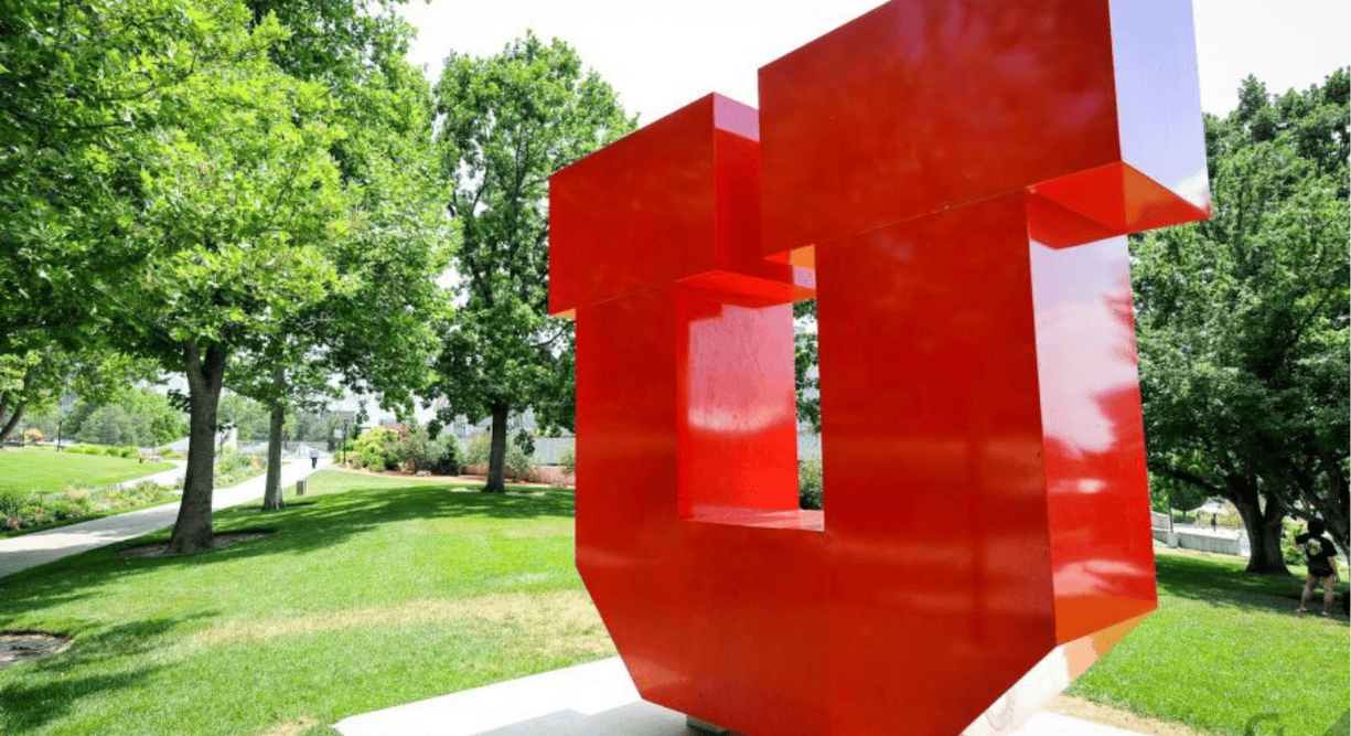The red block U surrounded by vibrant green grass